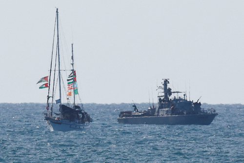 An Israeli navy vessel escorts a vessel from the Global Sumud Flotilla to Ashdod Port