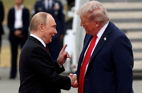 FILE PHOTO: U.S. President Donald Trump shakes hand with Russian President