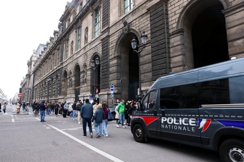 Police vehicle stands near the entrance to the Louvre museum after reports of a robbery, in Paris, France