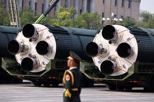 A member of the People's Liberation Army stands as the strategic strike group displays DF-5C nuclear missiles during a military parade to mark the 80th anniversary of the end of World War Two, in Beijing, China, September 3, 2025. REUTERS/Tingshu Wang