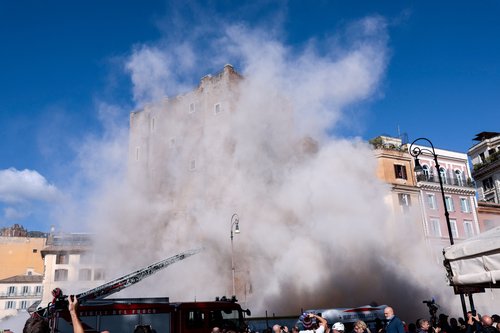 Dust rises as part of the Torre dei Conti tower collapses