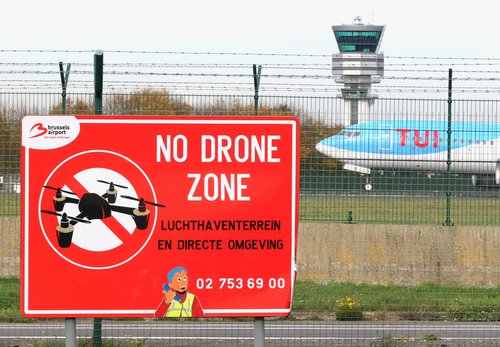 FILE PHOTO: An aircraft lands on the tarmac near a "No Drone Zone" placard on the day of an emergency meeting of Belgian government officials and experts