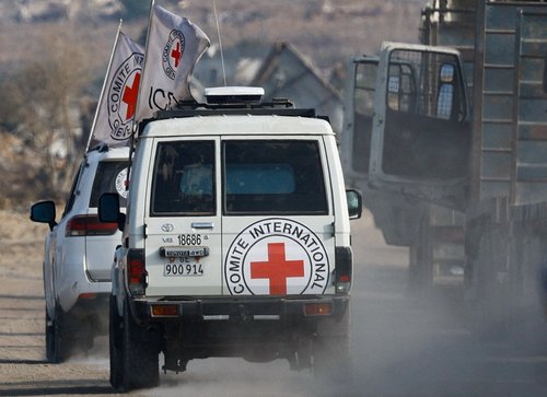 Red Cross vehicles transport a body, identified by Hamas as deceased Israeli soldier Hadar Goldin, in Deir Al-Balah