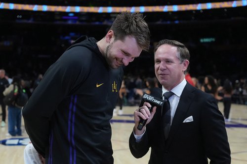 Nov 18, 2025; Los Angeles, California, USA; Los Angeles Lakers guard Luka Doncic (left) is interviewed by Spectrum SportsNet reporter Mike Trudell after the game against the Utah Jazz at Crypto.com Arena. Mandatory Credit: Kirby Lee-Imagn Images