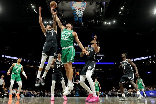 Nov 18, 2025; Brooklyn, New York, USA; Boston Celtics center Luka Garza (52) fights for a rebound against Brooklyn Nets forward Michael Porter Jr. (17) and guard Terance Mann (14) and center Nic Claxton (33) during the first quarter at Barclays Center. Ma