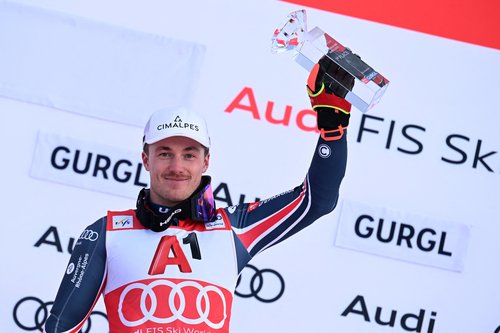 Alpine Skiing - FIS Alpine Ski World Cup - Men's Slalom - Gurgl, Austria - November 22, 2025 France's Paco Rassat celebrates with a trophy on the podium after winning the men's slalom REUTERS/Angelika Warmuth