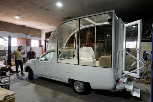 Palestinians work on the Vehicle of Hope, the former popemobile used by Pope Francis during its transformation into a fully equipped mobile clinic, in Bethlehem in the Israeli-occupied West Bank, May 20, 2025. REUTERS/Mussa Qawasma