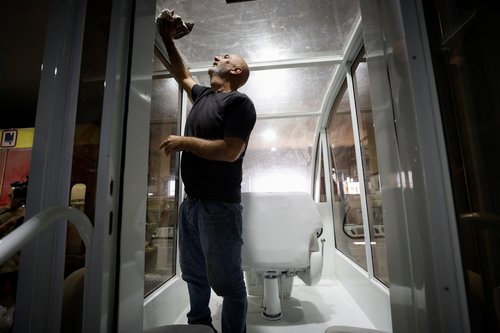 A Palestinian cleans the Vehicle of Hope, the former popemobile used by Pope Francis during its transformation into a fully equipped mobile clinic, in Bethlehem in the Israeli-occupied West Bank, May 20, 2025. REUTERS/Mussa Qawasma