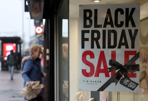 A shopper enters a shop promoting Black Friday retail discounts in Haywards Heath, Britain, November 27, 2025. REUTERS/Toby Melville