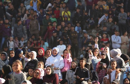Palestinians watch a mass wedding for 54 couples in Khan Younis, in the southern Gaza Strip December 2, 2025. REUTERS/Ramadan Abed