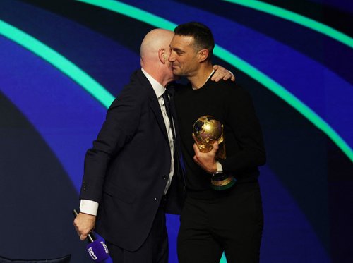 Soccer Football - FIFA World Cup 2026 - FIFA World Cup 2026 Match Schedule Announced - Washington, D.C., U.S. - December 6, 2025 FIFA President Gianni Infantino and Argentina coach Lionel Scaloni holding the FIFA World Cup trophy during the FIFA World Cup