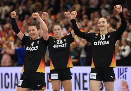 Handball - 2025 IHF World Women's Handball Championship - Quarter Final - Germany v Brazil - Westfalenhalle, Dortmund, Germany - December 9, 2025 Germany's Alina Grijseels, Nieke Kuhne and Emily Vogel celebrate after the match REUTERS/Leon Kuegeler