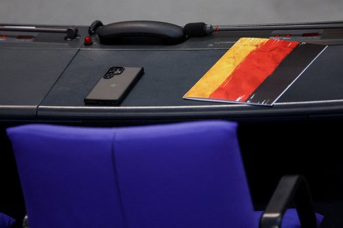 A folder in the colours of the German national flag is placed on a table next to the AFD member's seat before the session of a budget debate at the lower house of parliament, Bundestag, in Berlin, Germany, November 25, 2025. REUTERS/Lisi Niesner