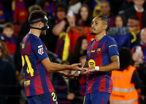 Soccer Football - LaLiga - FC Barcelona v Osasuna - Spotify Camp Nou, Barcelona, Spain - December 13, 2025 FC Barcelona's Raphinha celebrates scoring their second goal with Eric Garcia REUTERS/Albert Gea