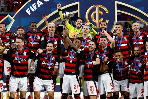 Soccer Football - FIFA Challenger Cup - Flamengo v Pyramids FC - Ahmad Bin Ali Stadium, Al-Rayyan, Qatar - December 13, 2025 Flamengo's Bruno Henrique lifts the trophy as he celebrates with teammates after winning the Challenger Cup REUTERS/Rula Rouhana