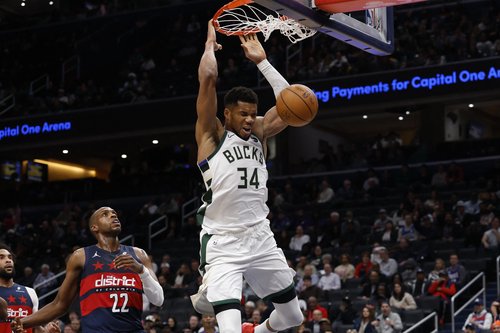 Dec 1, 2025; Washington, District of Columbia, USA; Milwaukee Bucks forward Giannis Antetokounmpo (34) dunks the ball as Washington Wizards forward Khris Middleton (22) looks on in the second quarter at Capital One Arena. Mandatory Credit: Geoff Burke-Ima