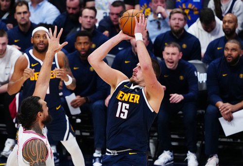 Dec 15, 2025; Denver, Colorado, USA; Denver Nuggets center Nikola Jokic (15) shoots the ball over Houston Rockets center Steven Adams (12) in the third quarter at Ball Arena. Mandatory Credit: Ron Chenoy-Imagn Images