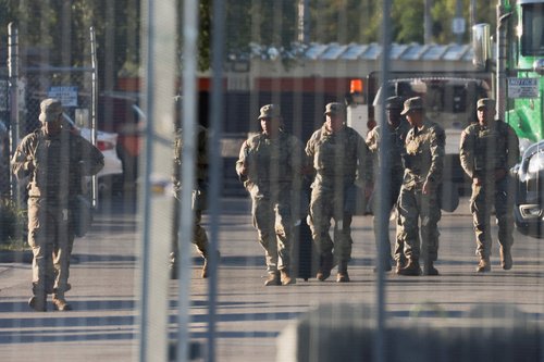FILE PHOTO: National Guard members walk at the U.S. Immigration and Customs Enforcement (ICE) Broadview facility in Chicago, Illinois, U.S., October 9, 2025. REUTERS/Jeenah Moon/File Photo