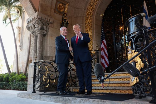 U.S. President Donald Trump greets Israeli Prime Minister Benjamin