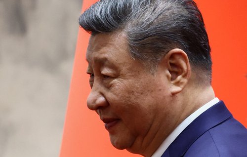 FILE PHOTO: Chinese President Xi Jinping looks on as he walks