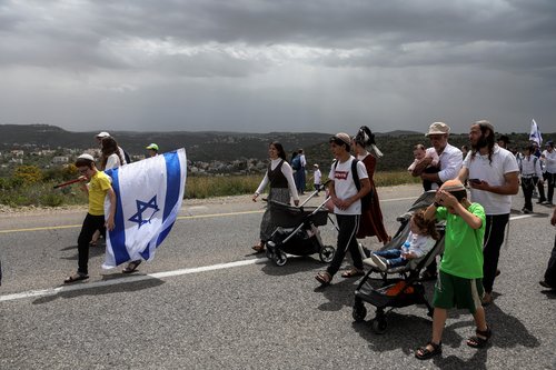 Israeli settlers hold a protest march in West Bank