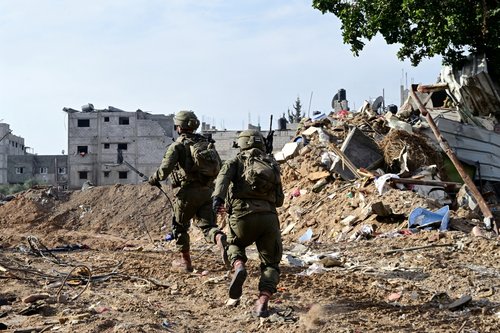 Israeli soldiers operate at the Shajaiya district of Gaza city amid the ongoing conflict between Israel and the Palestinian Islamist group Hamas, in the Gaza Strip