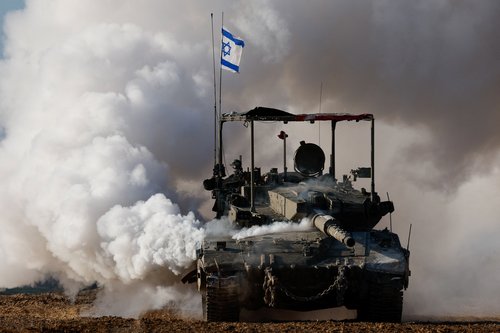 An Israeli tank manoeuvres near the Israel-Gaza border