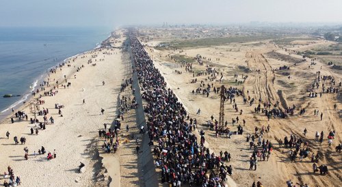 FILE PHOTO: Displaced Palestinians make their way back to their homes in northern Gaza, amid a ceasefire between Israel and Hamas, in the central Gaza Strip