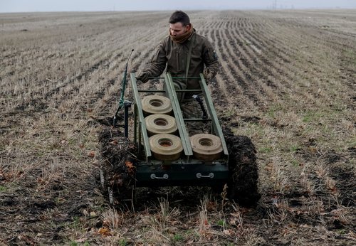 FILE PHOTO: A serviceman of the National Guard of Ukraine operates a mine-laying unmanned ground vehicle in Kharkiv region
