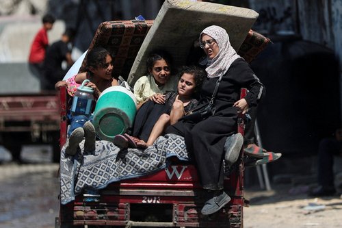 Displaced Palestinians travel on a cart loaded with belongings as they flee amid an Israeli military operation, in Gaza City, August 22, 2025. REUTERS/Mahmoud Issa TPX IMAGES OF THE DAY