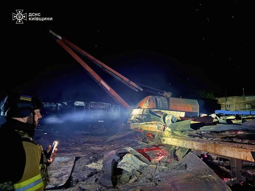 A police officer inspects the site of a private enterprise hit