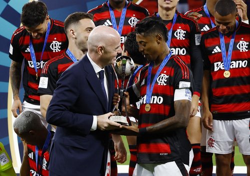 Soccer Football - FIFA Challenger Cup - Flamengo v Pyramids FC - Ahmad Bin Ali Stadium, Al-Rayyan, Qatar - December 13, 2025 Flamengo's Bruno Henrique is presented with the trophy by FIFA president Gianni Infantino as he celebrates with teammates after wi