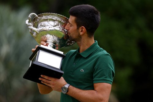 FILE PHOTO: Tennis - Australian Open - Men's Singles Photo Shoot - Government House, Melbourne, Australia - January 30, 2023 Australian Open champion Serbia's Novak Djokovic kisses the trophy during a photo shoot REUTERS/Hannah Mckay/File Photo