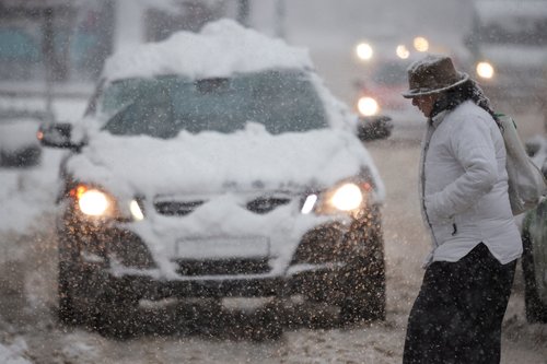 A woman crosses the street during a snowstorm in Sarajevo, Bosnia and Herzegovina January 04, 2026. REUTERS/Amel Emric