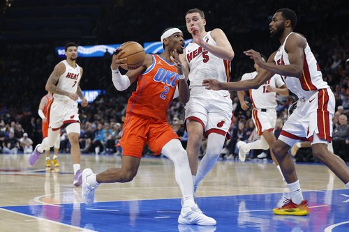 Jan 11, 2026; Oklahoma City, Oklahoma, USA; Oklahoma City Thunder guard Shai Gilgeous-Alexander (2) drives to the basket around Miami Heat forward Nikola Jović (5) during the second half at Paycom Center. Mandatory Credit: Alonzo Adams-Imagn Images