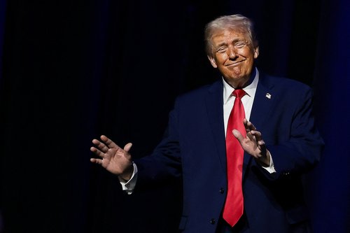 U.S. President Donald Trump gestures, at the Detroit Economic Club