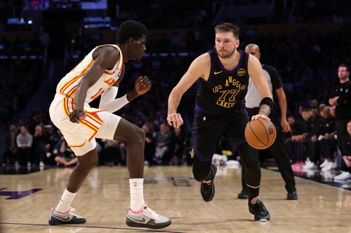 Jan 13, 2026; Los Angeles, California, USA; Los Angeles Lakers guard Luka Doncic (77) dribbles the ball against Atlanta Hawks forward Mouhamed Gueye (18) during the third quarter at Crypto.com Arena. Mandatory Credit: Kiyoshi Mio-Imagn Images