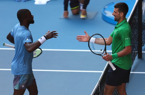 Tennis - Australian Open - Melbourne Park, Melbourne, Australia - January 15, 2026 Serbia's Novak Djokovic shakes hands with Frances Tiafoe of the U.S. after winning the exhibition match REUTERS/Edgar Su
