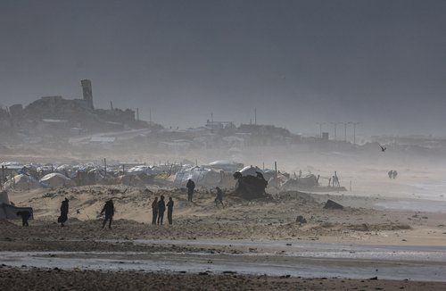 Palestinians gather near tents sheltering displaced people, amid a windstorm, in Gaza City, January 13, 2026. REUTERS/Dawoud Abu Alkas TPX IMAGES OF THE DAY
