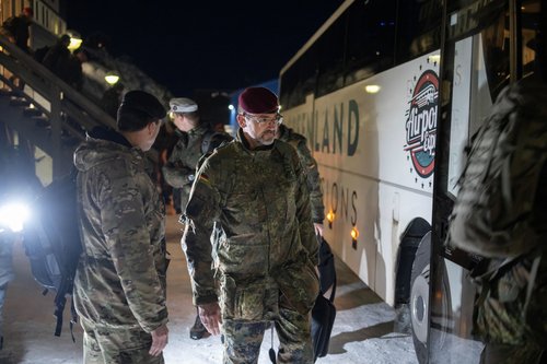 Soldiers from the German Armed Forces board a bus upon their arrival