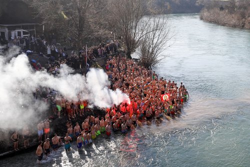 Participants cheer in cold water of Moraca river