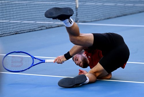Tennis - Australian Open - Melbourne Park, Melbourne, Australia - January 20, 2026 France's Hugo Gaston falls during his first round match against Italy's Jannik Sinner REUTERS/Jaimi Joy