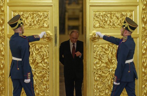 Russian President Vladimir Putin enters a hall during a ceremony to recei