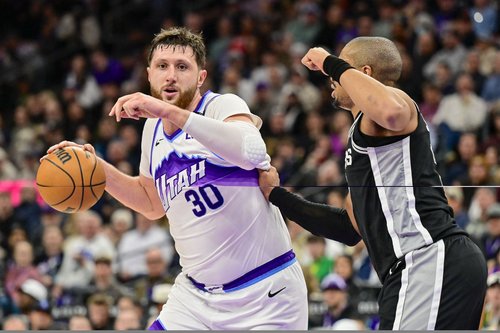 Jan 22, 2026; Salt Lake City, Utah, USA; Utah Jazz center Jusuf Nurkić (30) drives toward the basket against San Antonio Spurs forward/guard Keldon Johnson (3) during the second half at Delta Center. Mandatory Credit: Peter Creveling-Imagn Images