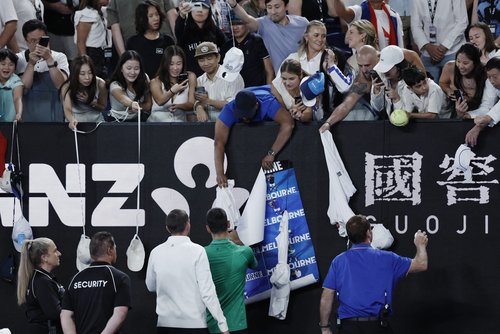 Tennis - Australian Open - Melbourne Park, Melbourne, Australia - January 24, 2026 Serbia's Novak Djokovic signs autographs for fans after winning his third round match against Netherlands' Botic van de Zandschulp REUTERS/Tingshu Wang
