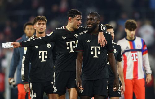 Soccer Football - Bundesliga - FC Cologne v Bayern Munich - RheinEnergieStadion, Cologne, Germany - January 14, 2026 Bayern Munich's Dayot Upamecano and Aleksandar Pavlovic celebrate after the match REUTERS/Thilo Schmuelgen DFL REGULATIONS PROHIBIT ANY US