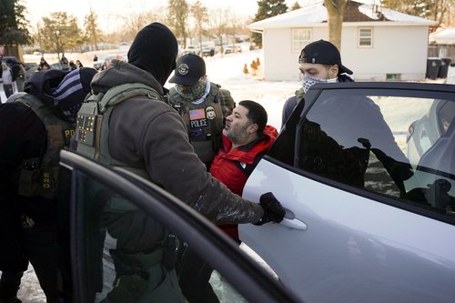Federal agents detain a man as they conduct immigration enforcement action in Saint Paul, Minnesota, U.S., January 27, 2026. REUTERS/Seth Herald
