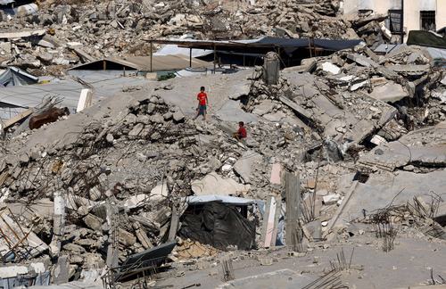 FILE PHOTO: Young Palestinians amid the rubble of buildings destroyed during the war, at Jabalia refugee camp in the northern Gaza Strip