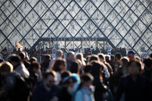 Protesters and students from art and culture schools block the entrance to the Louvre Museum