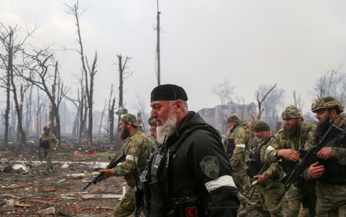 FILE PHOTO: Fighters of the Chechen special forces unit walk in Mariupol